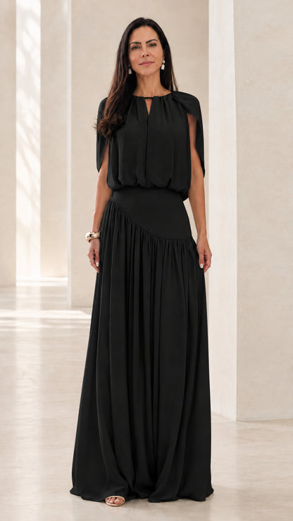 Front view of model wearing Black cape sleeve asymmetrical maxi dress