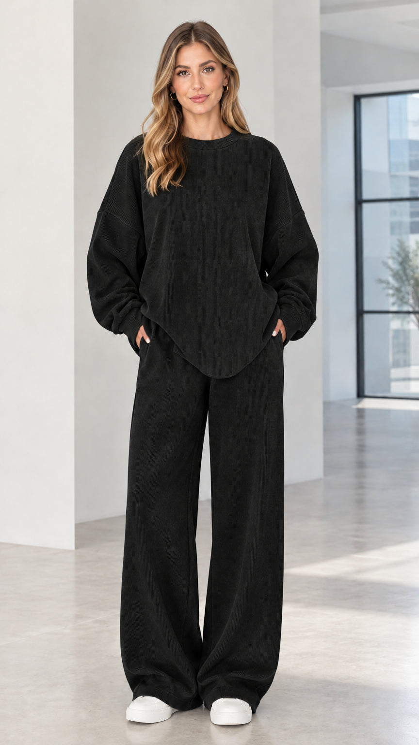 Woman wearing black two-piece ribbed crewneck top and wide-leg lounge pants set