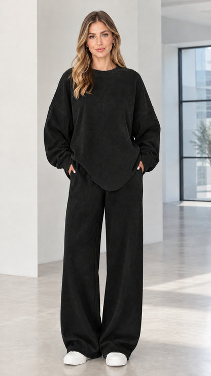 Woman wearing black two-piece ribbed crewneck top and wide-leg lounge pants set