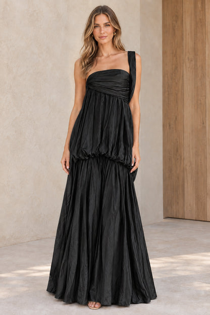 Front view of black one-shoulder tiered pleated maxi evening gown