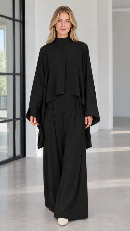 Front view of elegant black mock neck cape top and wide leg palazzo pants set