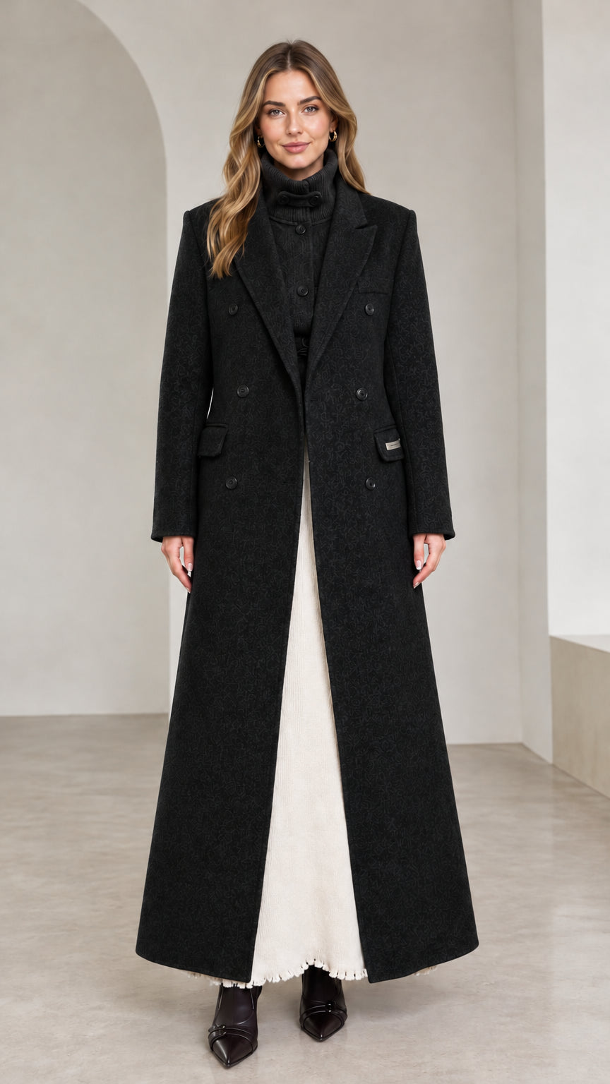 Front view of black double-breasted tailored floor-length overcoat