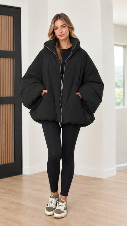 Model wearing black oversized zip-up bubble puffer jacket
