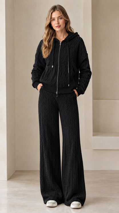 Full-length view of woman wearing black cable knit zip-up hoodie and wide leg lounge pants
