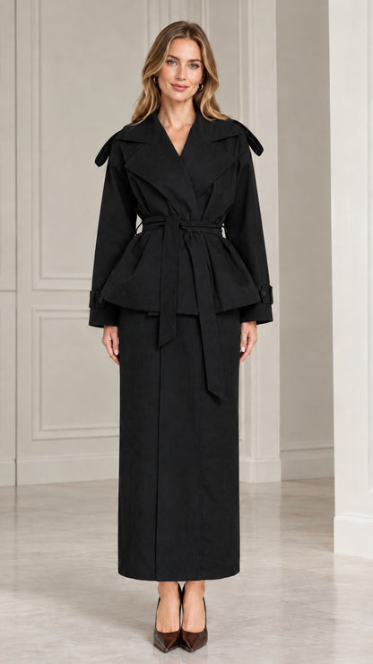 Front view of model wearing black belted peplum jacket and maxi skirt set