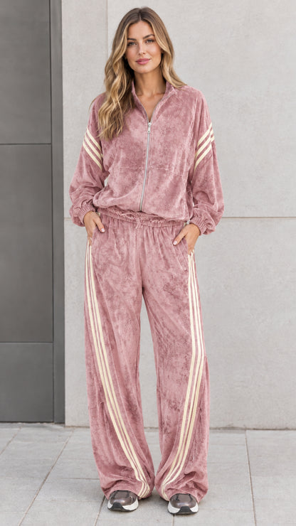 Front view of model wearing dusty rose pink velour tracksuit set with cream stripes