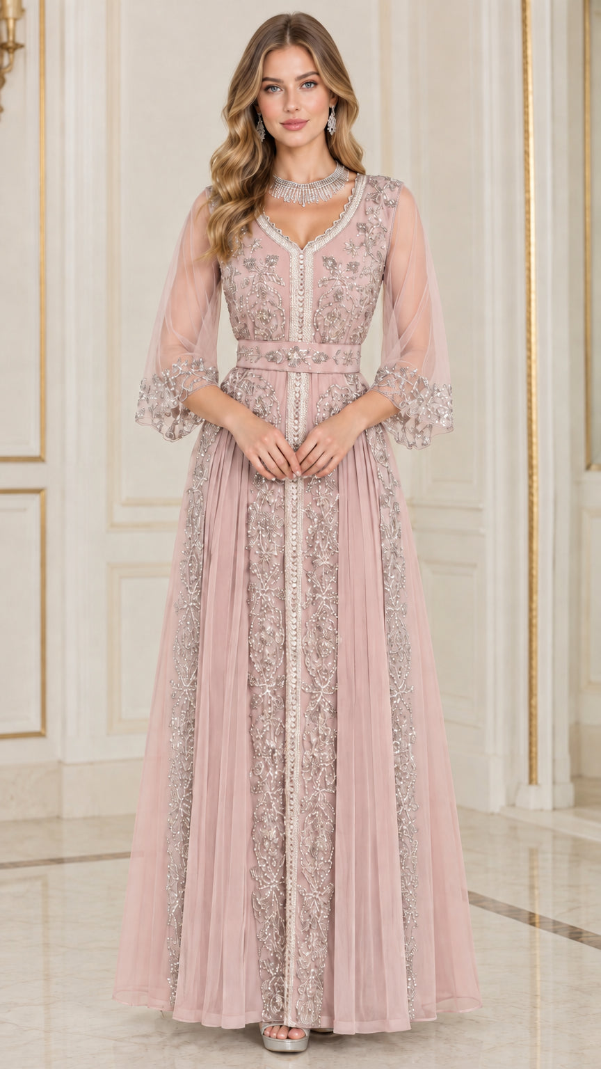 Front full-length view of woman in dusty pink embroidered beaded formal maxi dress