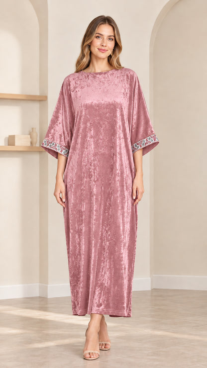 Front view of model wearing dusty pink crushed velvet kaftan maxi dress