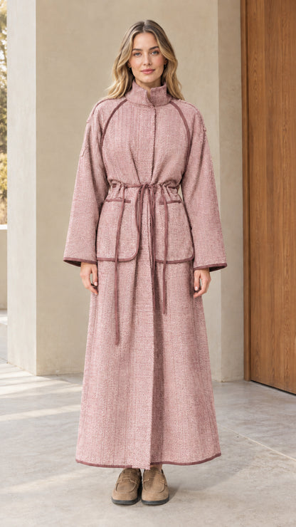 Full-length view of woman wearing dusty rose pink herringbone maxi coat