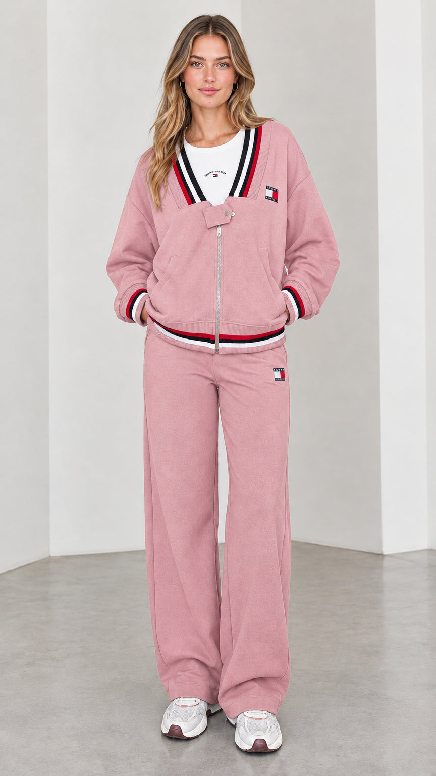 Front view of model wearing dusty pink varsity striped tracksuit set