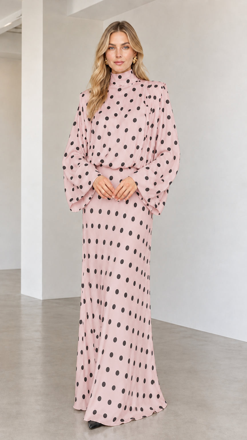 Model wearing blush pink polka dot long sleeve high neck maxi dress