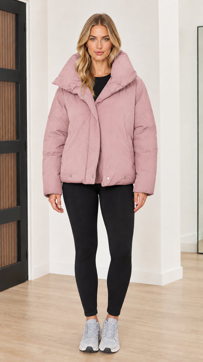 Front view of woman wearing dusty pink funnel collar puffer jacket