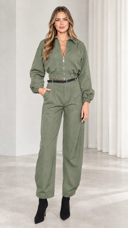 Front view of model wearing sage green long sleeve utility jumpsuit
