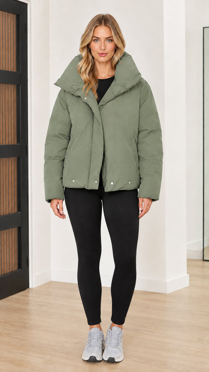 Front view of woman wearing sage green funnel collar puffer jacket