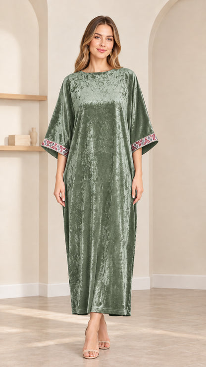 Front view of model wearing sage green crushed velvet kaftan maxi dress