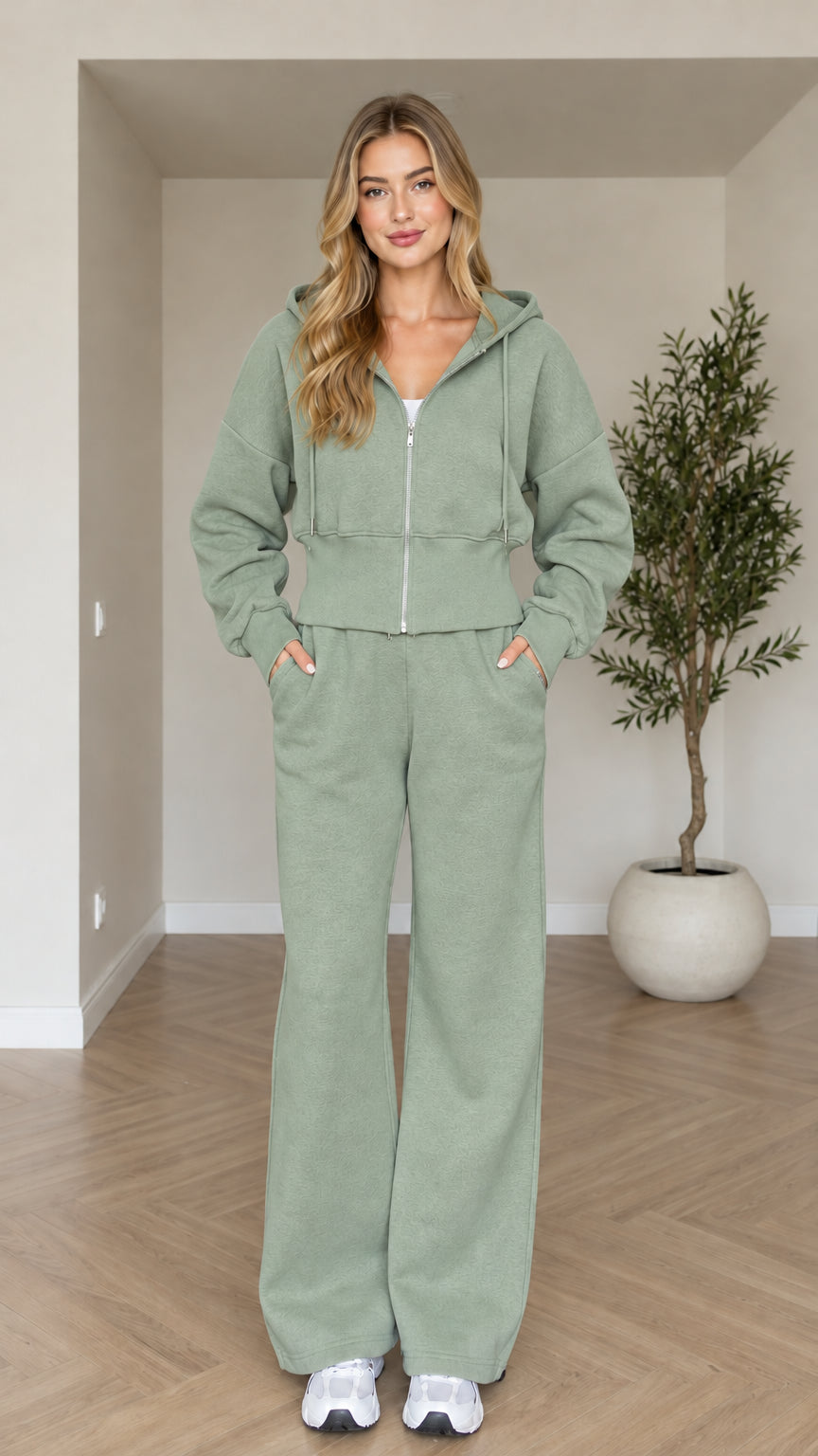 Front view of woman wearing sage green cropped zip hoodie and wide-leg sweatpants set