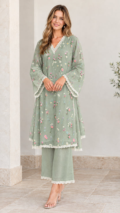 Full-length view of woman wearing sage green floral embroidered tunic and pant set