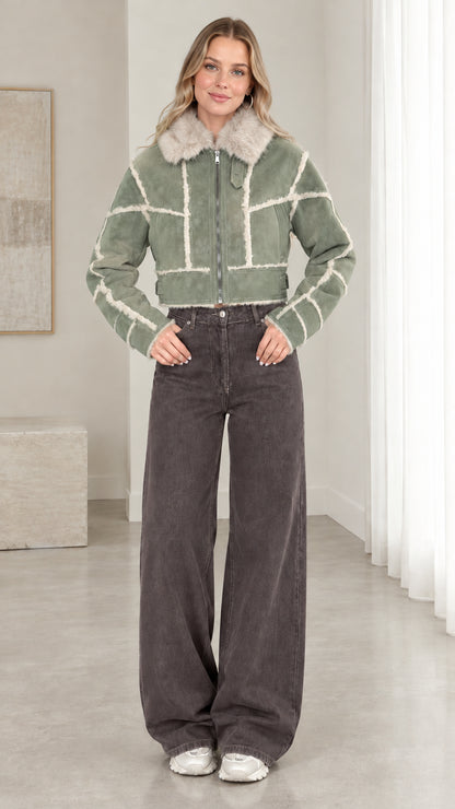 Model wearing sage green cropped faux suede shearling jacket
