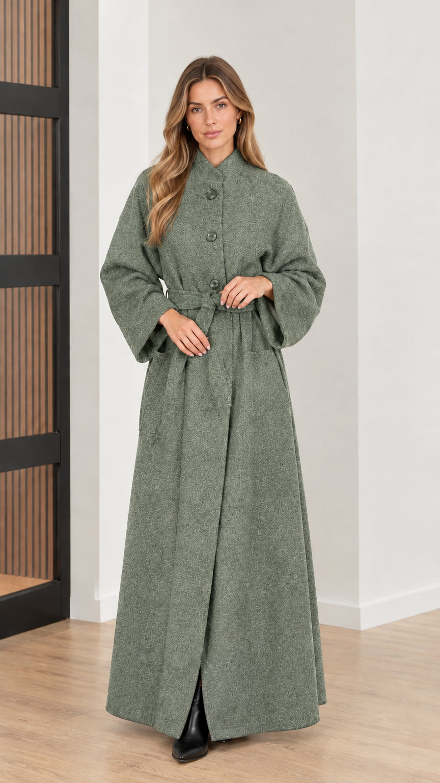 Front view of woman wearing sage green belted maxi overcoat