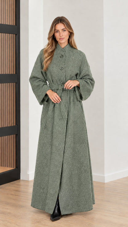 Front view of woman wearing sage green belted maxi overcoat