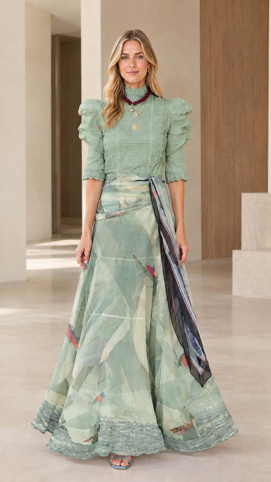 Full-length view of sage green puff sleeve top and sage abstract print maxi skirt