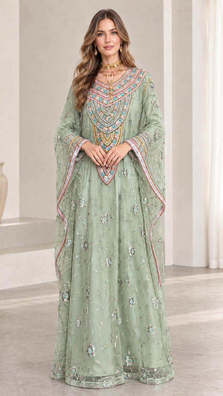 Front full-length view of woman wearing sage green embroidered kaftan gown