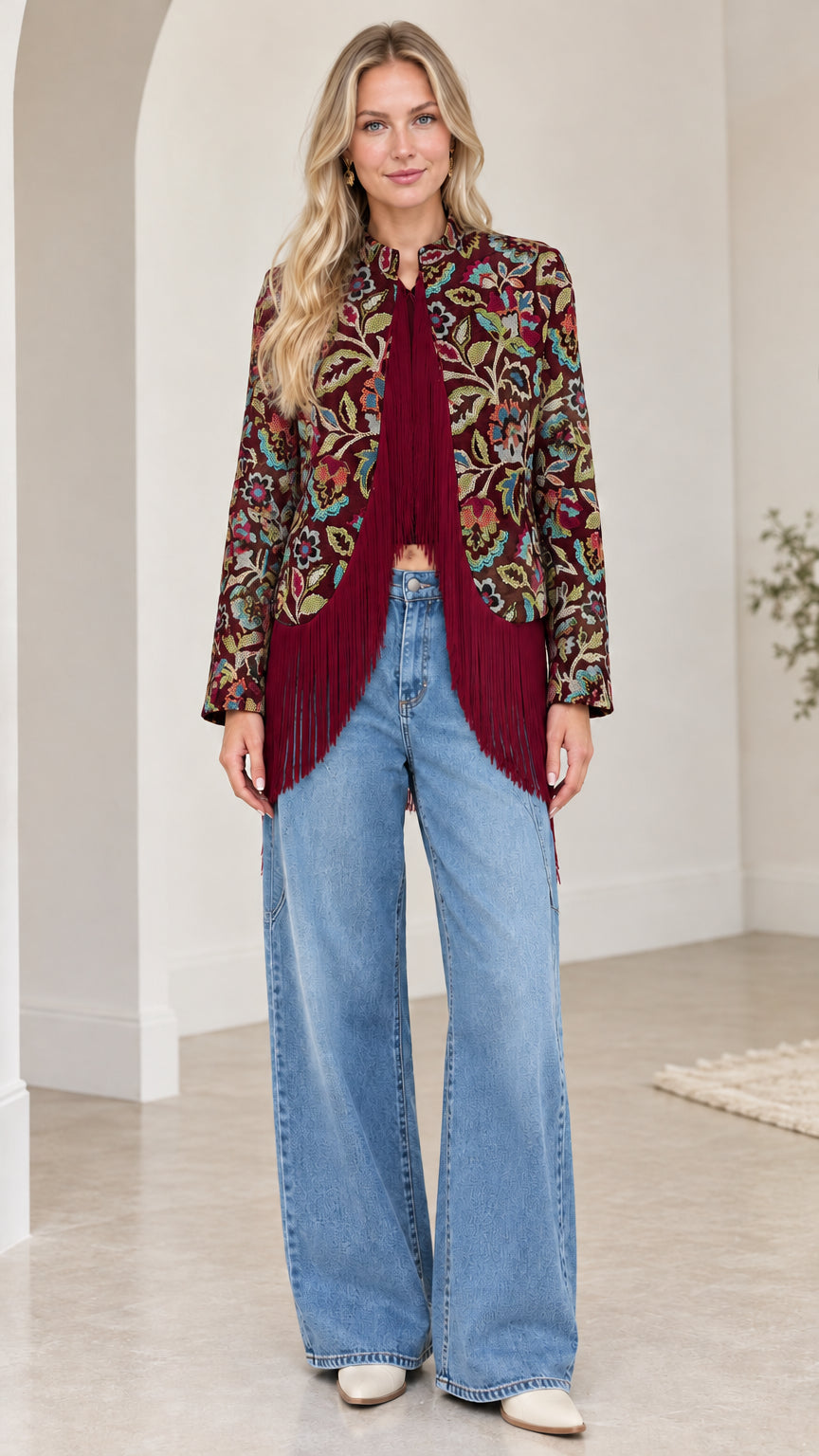 Model wearing deep burgundy floral jacquard fringe jacket with wine-toned tassels