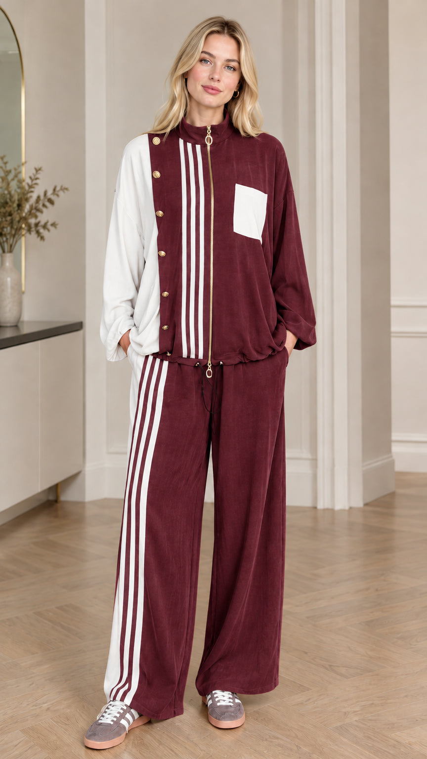 Full-body view of woman wearing burgundy wine red colorblock tracksuit set