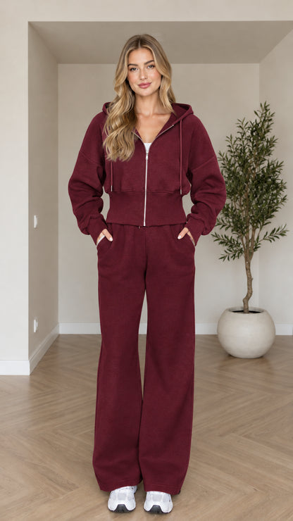 Front view of woman wearing burgundy cropped zip hoodie and wide-leg sweatpants set
