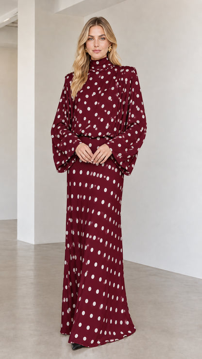 Model wearing burgundy red polka dot long sleeve high neck maxi dress