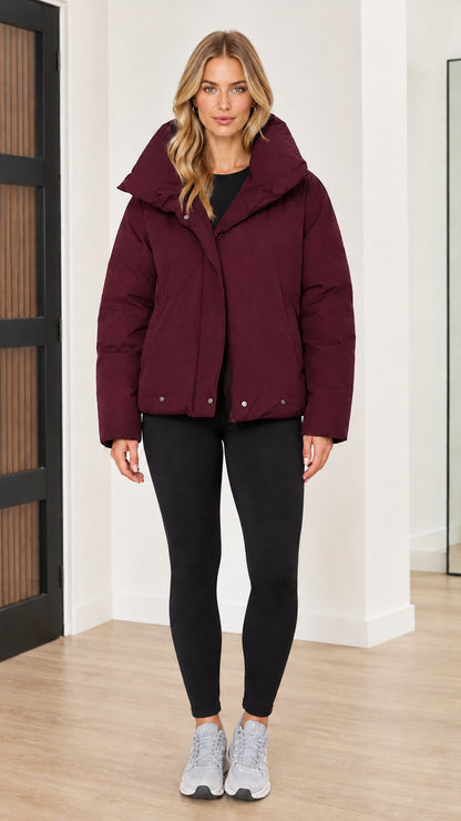 Front view of woman wearing burgundy wine red funnel collar puffer jacket