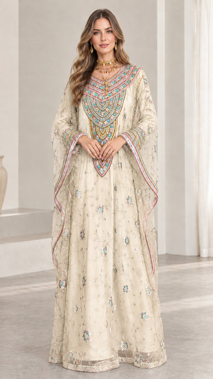 Front full-length view of woman wearing champagne cream embroidered kaftan maxi dress
