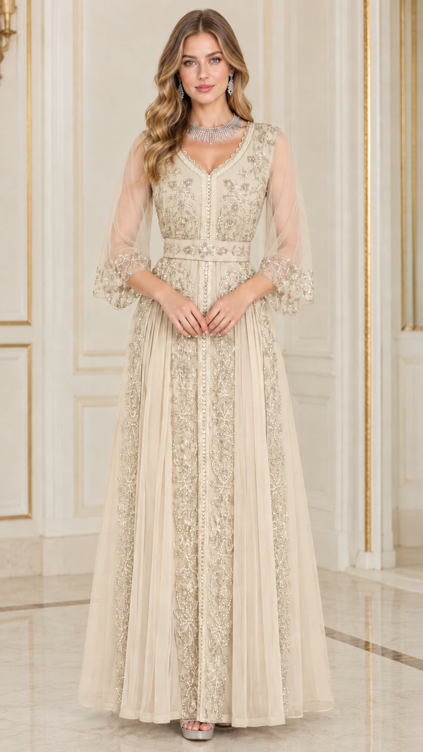 Front full-length view of woman in champagne beige embellished formal maxi gown