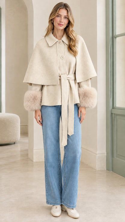Model wearing Cream ivory belted cape jacket with tonal faux fur cuffs