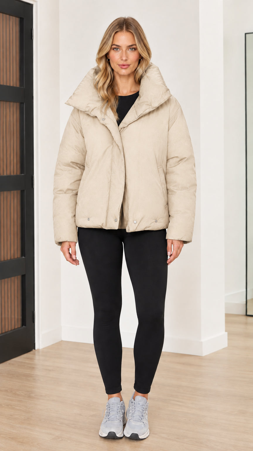 Front view of woman wearing cream beige funnel collar puffer jacket