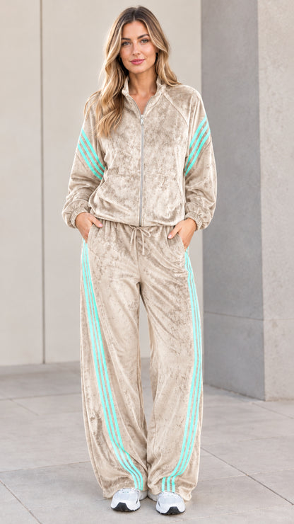 Model wearing beige champagne velour tracksuit set with contrast stripes