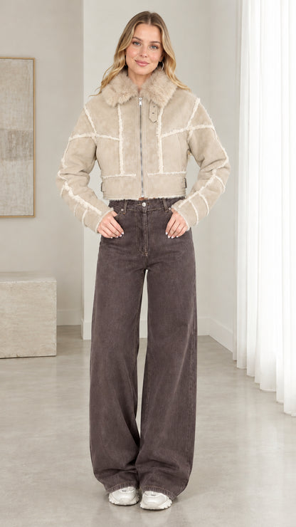 Model wearing beige cropped faux suede shearling jacket