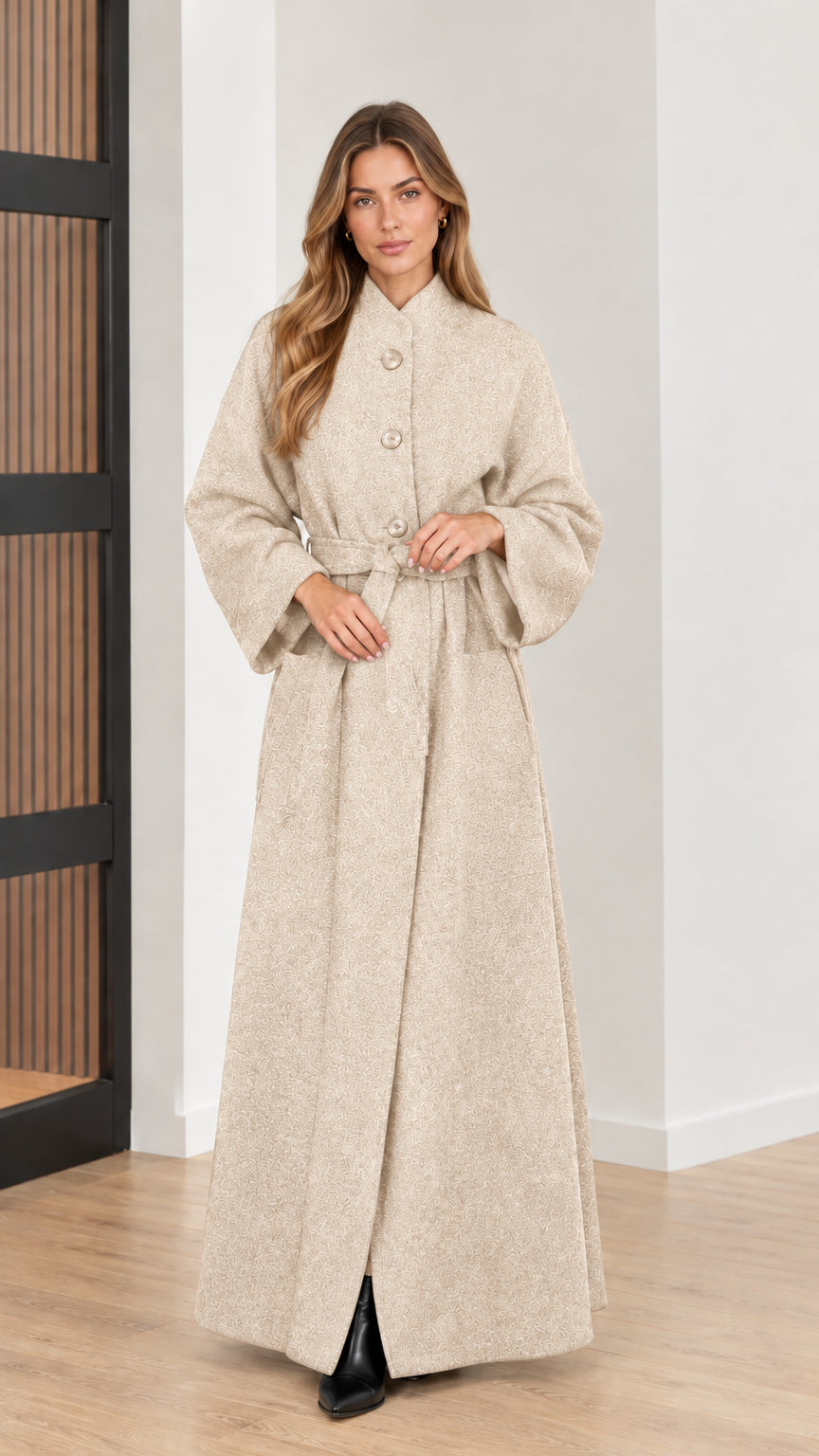 Front view of woman wearing cream beige belted maxi overcoat