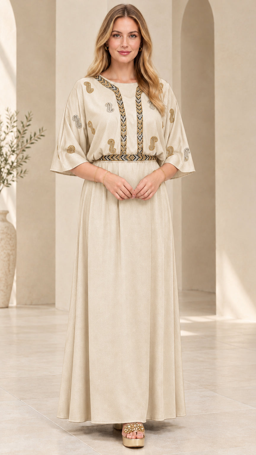 Front view of model wearing the champagne beige embellished kaftan maxi dress