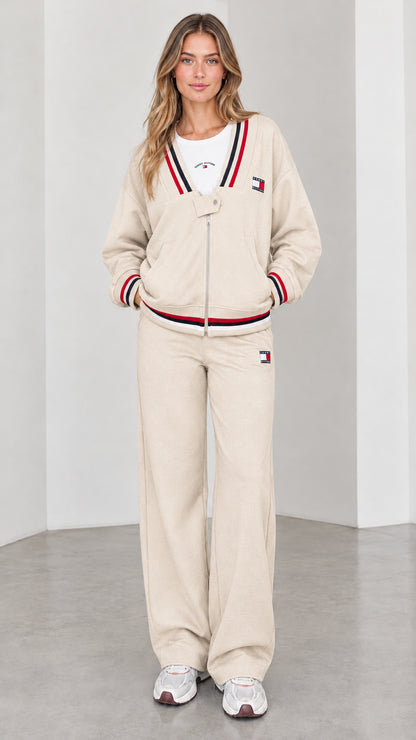 Front view of model wearing beige cream varsity striped tracksuit set