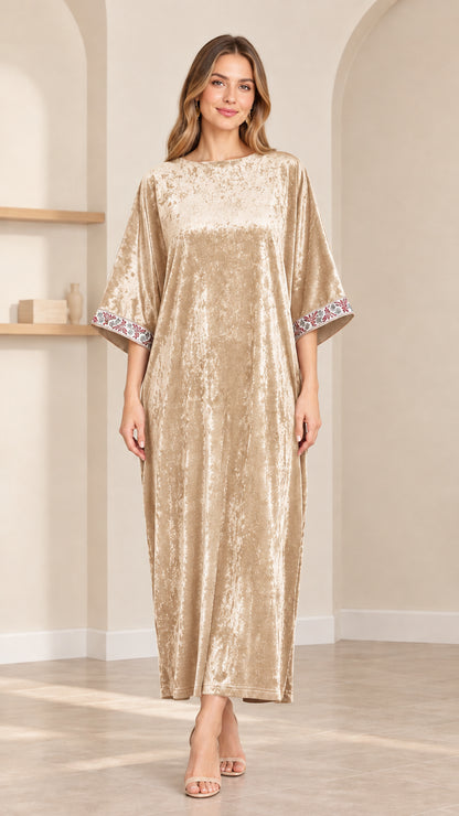 Front view of model wearing champagne gold crushed velvet kaftan maxi dress